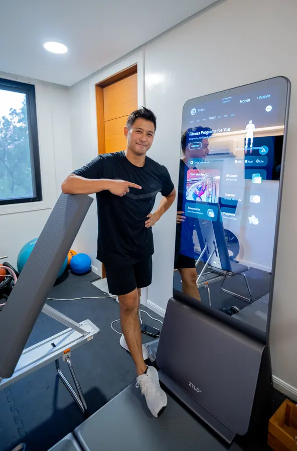 Rocco Nacino smiles and points at the lit ZYLO K1 screen beside him.
